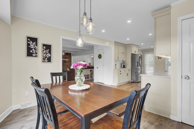 dining space with light hardwood / wood-style flooring