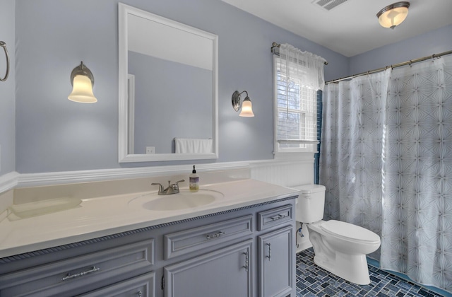 bathroom with tile patterned flooring, vanity, and toilet