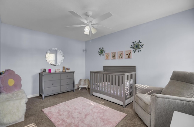 carpeted bedroom with a nursery area and ceiling fan