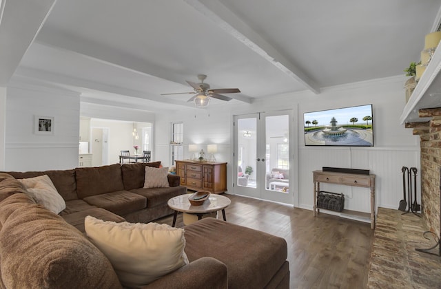 living room with dark wood-type flooring, ceiling fan, a fireplace, french doors, and beamed ceiling