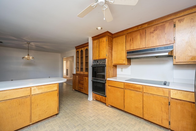 kitchen featuring ceiling fan, black appliances, and decorative light fixtures