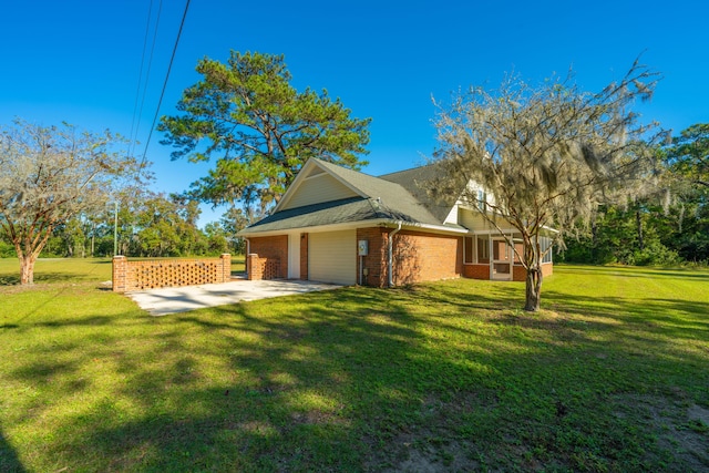 view of side of property with a lawn and a sunroom