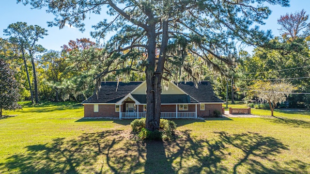 view of side of home with a lawn and a porch