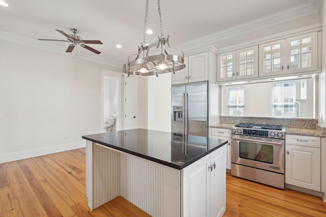 kitchen with crown molding, white cabinetry, light wood-type flooring, and stainless steel appliances