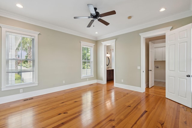 unfurnished bedroom featuring light wood-type flooring, visible vents, multiple windows, and baseboards