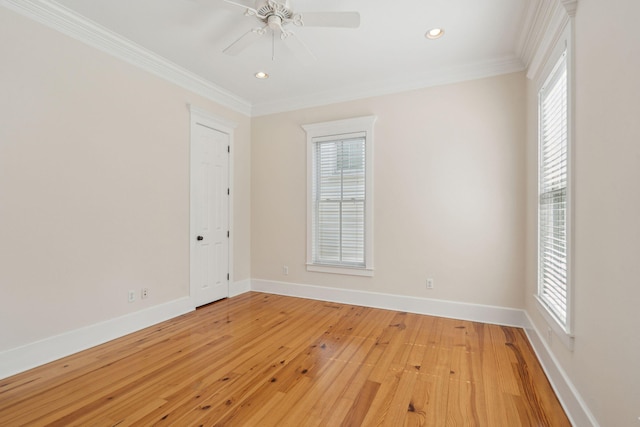 empty room featuring light wood-style flooring, ornamental molding, baseboards, and a healthy amount of sunlight