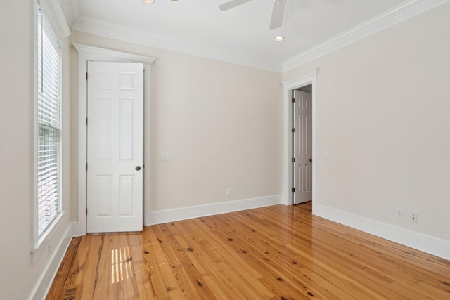 unfurnished room with crown molding, a healthy amount of sunlight, and baseboards