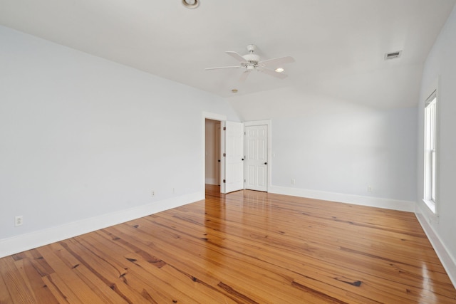 unfurnished room featuring visible vents, baseboards, a ceiling fan, vaulted ceiling, and light wood-style flooring