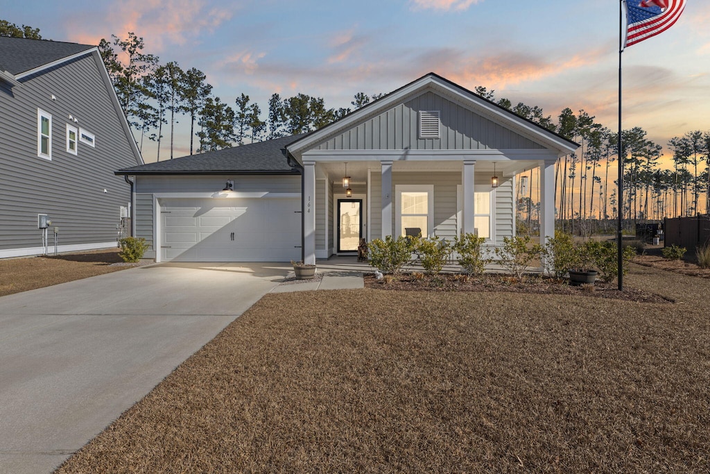 view of front of house featuring covered porch and a garage