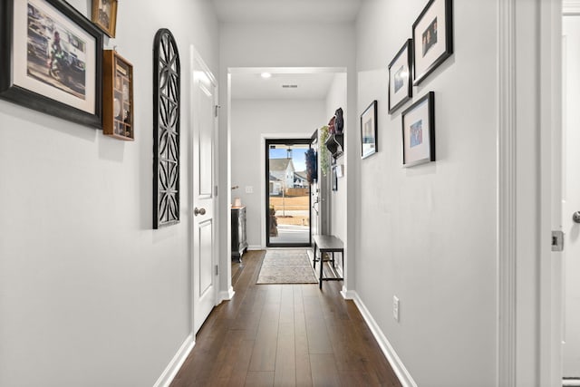 hallway with dark hardwood / wood-style flooring