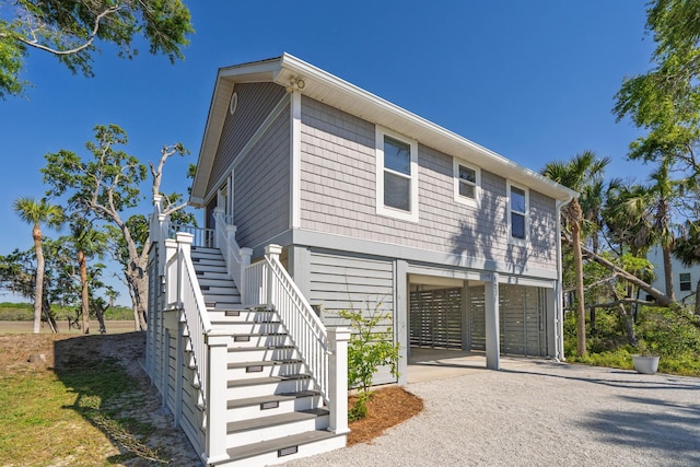 123 Jungle Rd, Edisto Island, SC 29438 - view of home's exterior with a carport, stairs, and gravel driveway