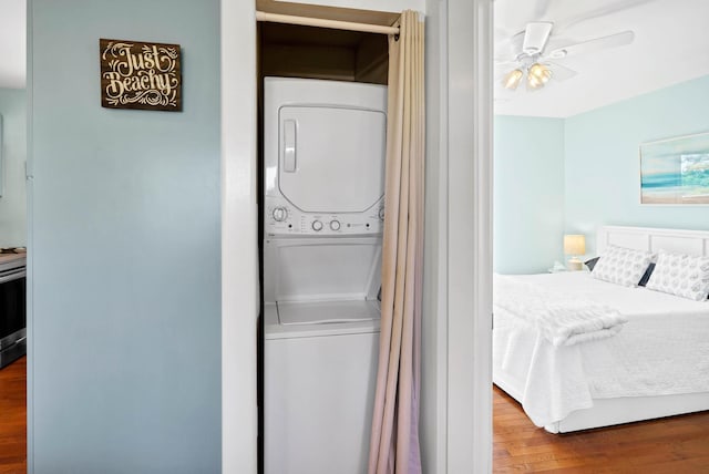 123 Jungle Rd, Edisto Island, SC 29438 - laundry room featuring estacked washer and dryer, wood finished floors, and ceiling fan