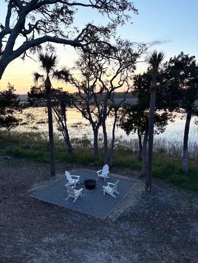 123 Jungle Rd, Edisto Island, SC 29438 - yard at dusk with an outdoor fire pit