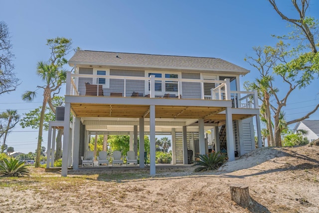 123 Jungle Rd, Edisto Island, SC 29438 - back of house featuring stairs, a wooden deck, and roof with shingles