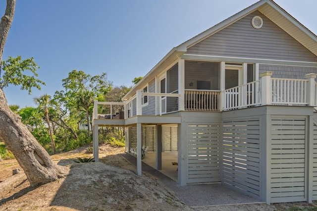 123 Jungle Rd, Edisto Island, SC 29438 - back of house featuring a sunroom and a deck