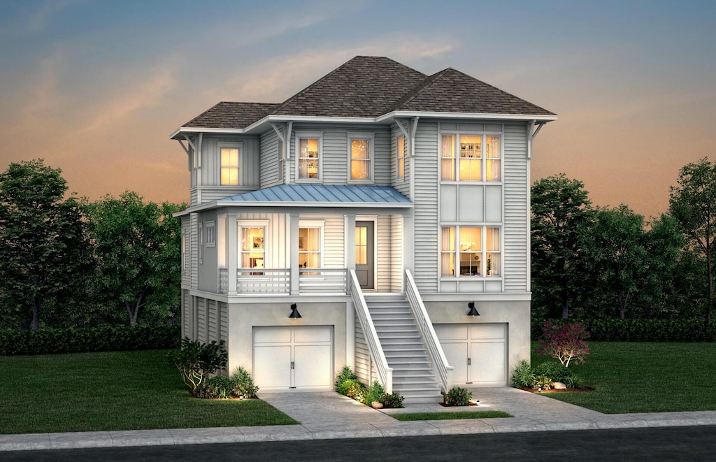 beach home with driveway, a yard, stairs, and stucco siding