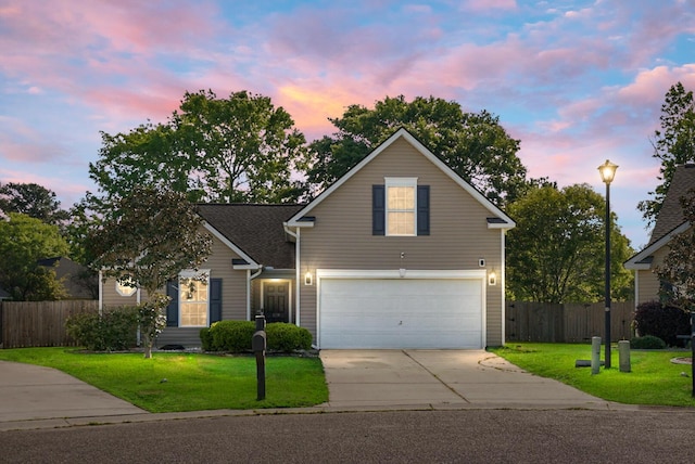 traditional home with a yard, fence, and driveway