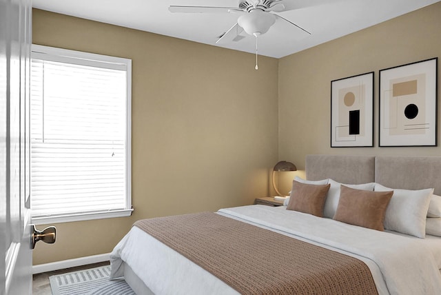 bedroom with baseboards and a ceiling fan