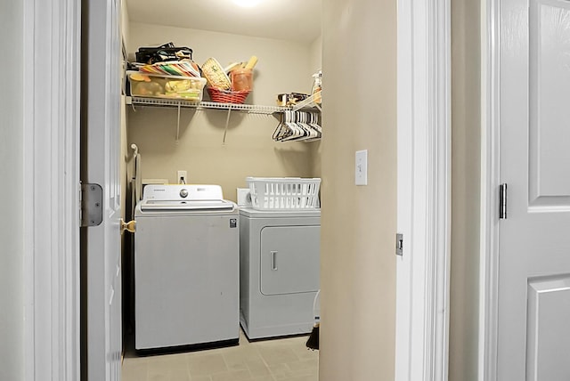 washroom with separate washer and dryer and laundry area