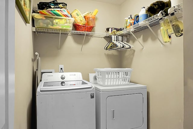 clothes washing area with laundry area and washer and clothes dryer