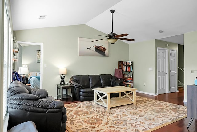 living room with ceiling fan, dark wood-style flooring, visible vents, vaulted ceiling, and baseboards