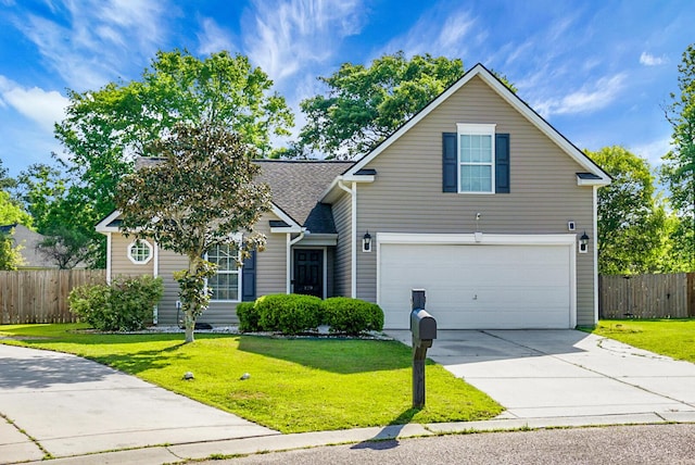 traditional-style house with concrete driveway, fence, a front yard, and a garage