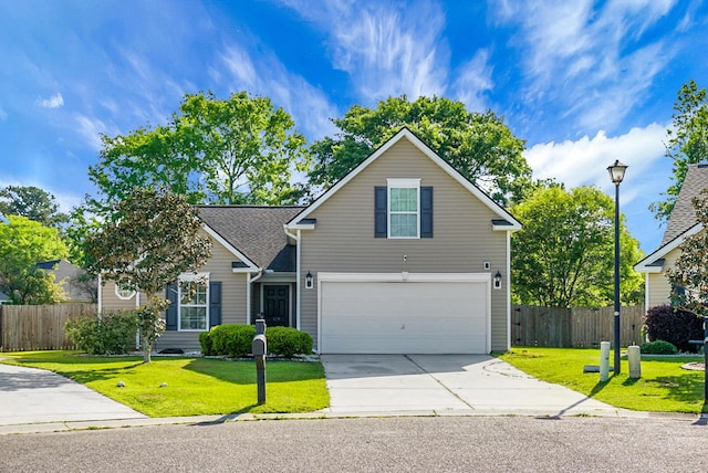 traditional-style home featuring a garage, a front lawn, fence, and driveway