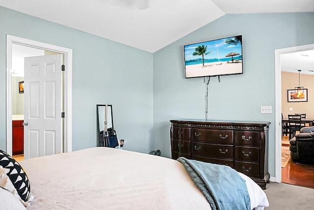 bedroom featuring carpet floors and vaulted ceiling