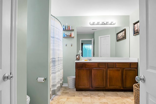 bathroom featuring toilet, a shower with curtain, and vanity