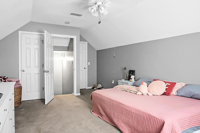 bedroom with a ceiling fan, visible vents, light carpet, and lofted ceiling