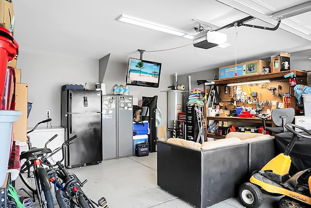 garage with freestanding refrigerator, a workshop area, a garage door opener, and gas water heater