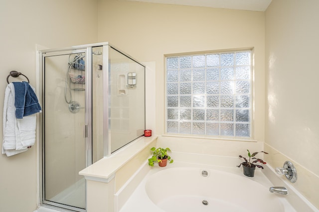 bathroom featuring separate shower and tub