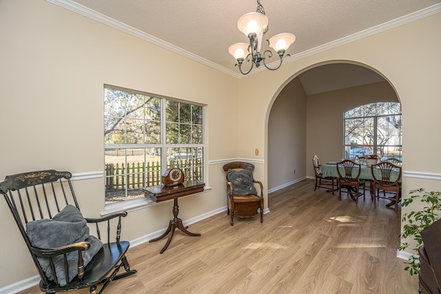 sitting room featuring plenty of natural light, a textured ceiling, a chandelier, and light hardwood / wood-style flooring