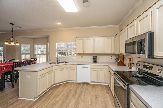 7011 Windmill Creek Rd, Charleston, SC 29414 - kitchen featuring appliances with stainless steel finishes, crown molding, light wood finished floors, a peninsula, and light countertops