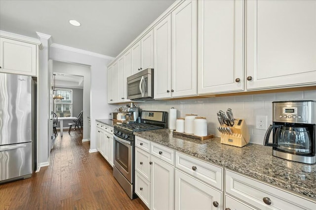 kitchen with white cabinetry, appliances with stainless steel finishes, and decorative backsplash