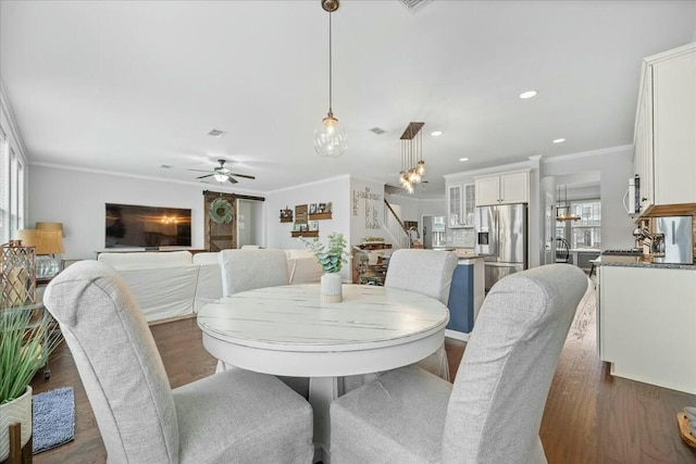 dining area with crown molding, ceiling fan, and dark hardwood / wood-style floors