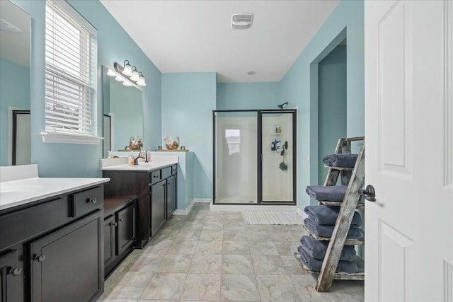 bathroom with vanity and a shower with shower door