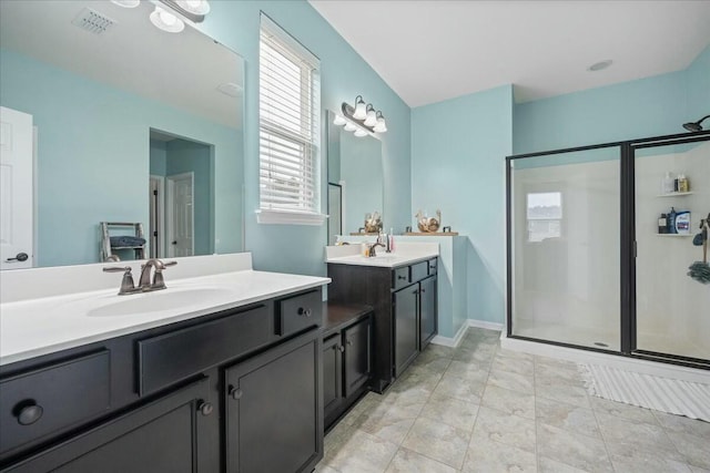 bathroom with vanity, a shower with shower door, and tile patterned floors