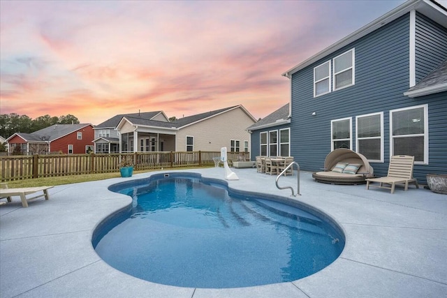 pool at dusk with a patio