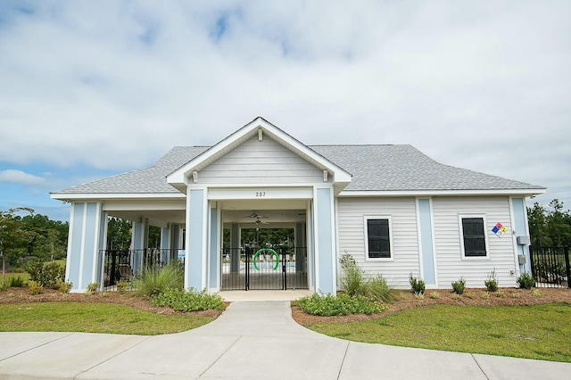 view of front of house with a front yard and ceiling fan