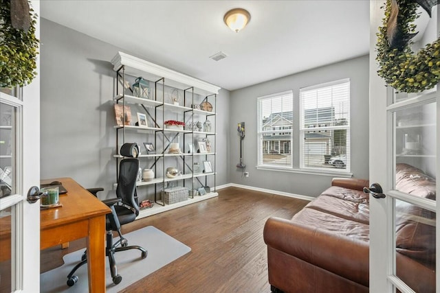 home office featuring dark hardwood / wood-style flooring and french doors