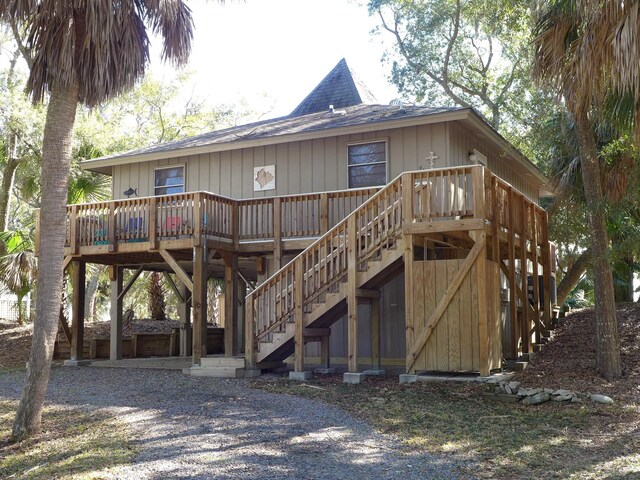 back of property featuring a wooden deck