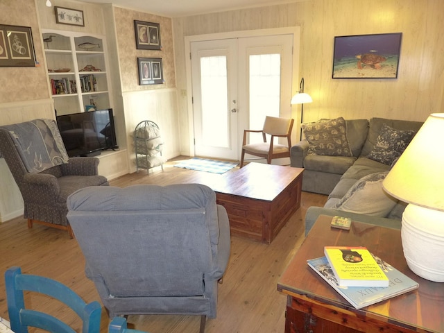 living room featuring french doors and light wood-type flooring