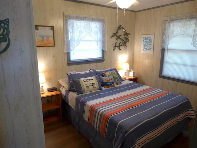 bedroom with crown molding and wood-type flooring