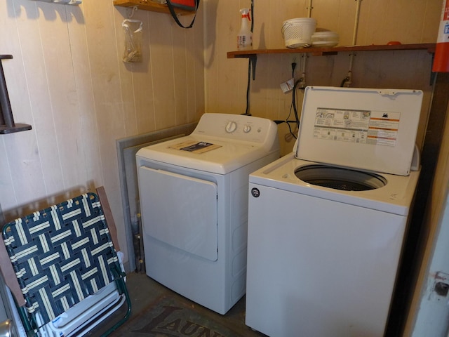 washroom featuring independent washer and dryer and wood walls