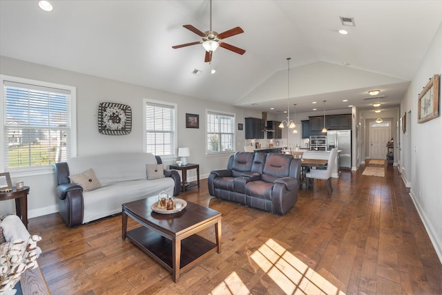 living room with dark wood-type flooring, vaulted ceiling, and plenty of natural light