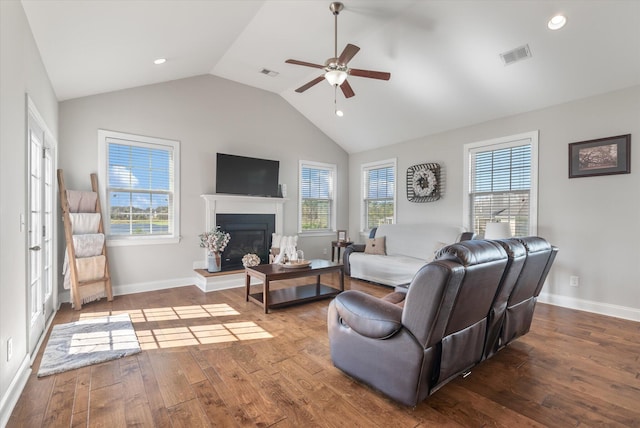 living room with ceiling fan, vaulted ceiling, plenty of natural light, and hardwood / wood-style floors