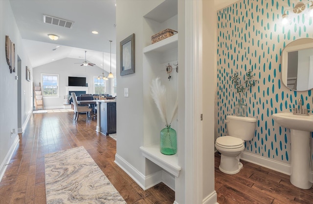 bathroom featuring ceiling fan, hardwood / wood-style flooring, vaulted ceiling, toilet, and sink