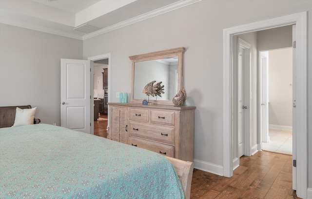 bedroom with crown molding and dark hardwood / wood-style floors