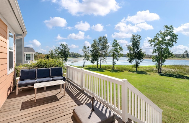 deck featuring a yard, a water view, and an outdoor hangout area